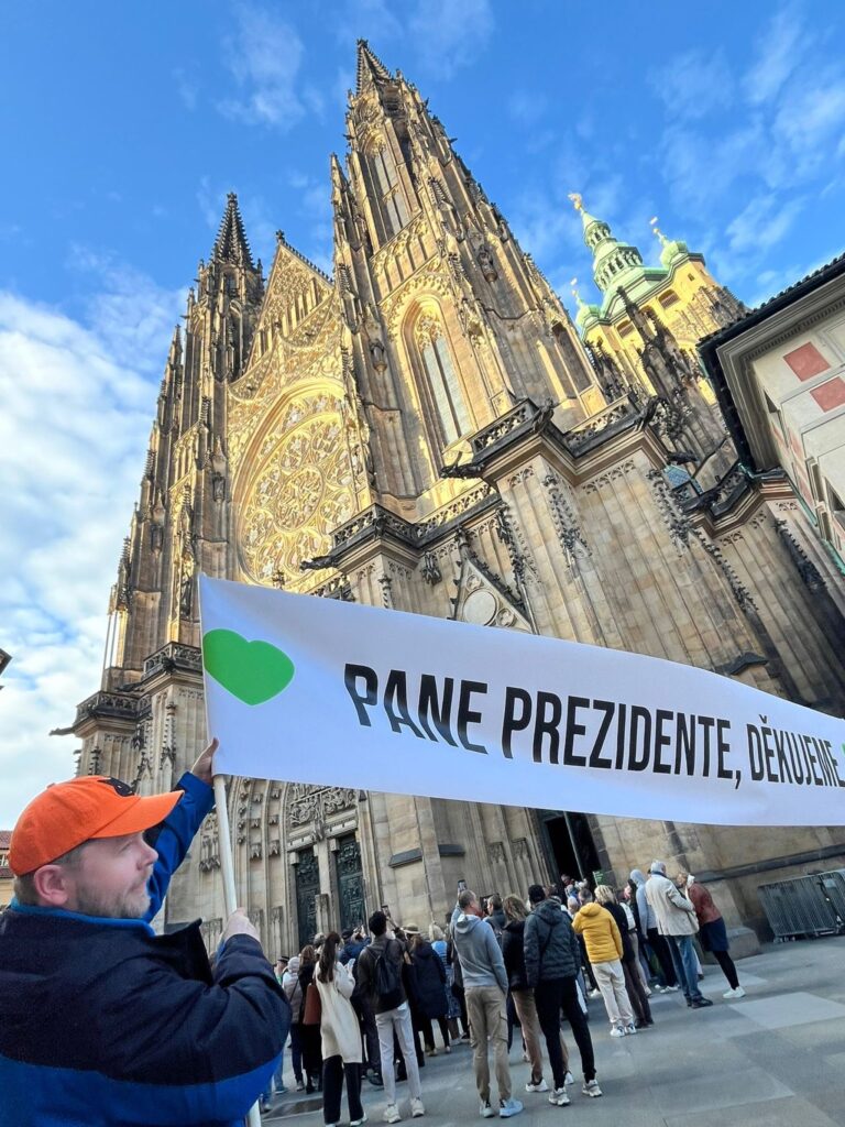 Cannabis advocates holding a banner in front of the St. Vitus Cathedral in Prague Czechia
